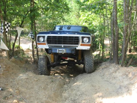 1978 Ford Bronco - This lifted Ford Bronco navigates an off-road course marked with checkered flags.