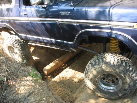1978 Ford Bronco - 1978 Ford Bronco navigating a challenging off-road obstacle.