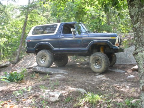 1978 Ford Bronco - 1978 Ford Bronco tackling rough terrain on an off-road trail.
