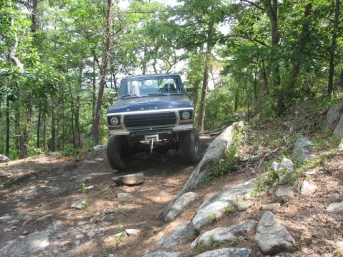 1978 Ford Bronco - This 1978 Ford Bronco navigates a challenging, rocky trail through a wooded area.