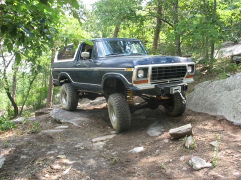 1978 Ford Bronco - This 1978 Ford Bronco is navigating a challenging off-road course with large rocks and uneven terrain.