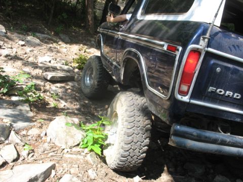 1978 Ford Bronco - This 1978 Ford Bronco is shown tackling a challenging off-road course with large tires and a lifted suspension.