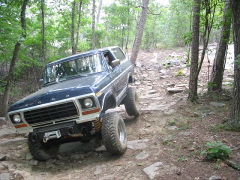 1978 Ford Bronco - This 1978 Ford Bronco navigates a challenging, rocky path through a wooded area.