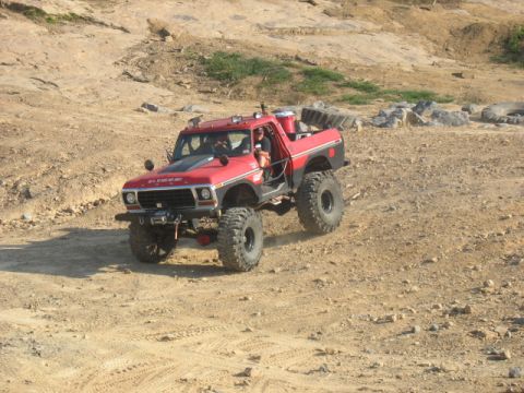 1978 Ford Bronco - Modified 1978 Ford Bronco tackling rough terrain with oversized tires and a lifted suspension.
