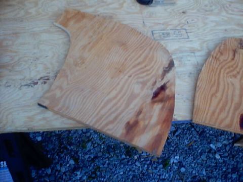 1999 Ford Taurus - Plywood pieces are laid out on a workbench, suggesting a crafting or construction project.