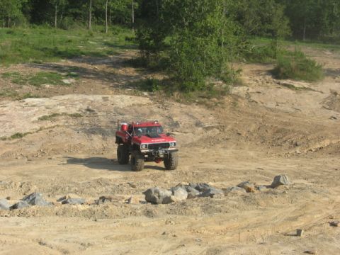 1978 Ford Bronco - A red 1978 Ford Bronco is shown in a rocky, off-road environment.