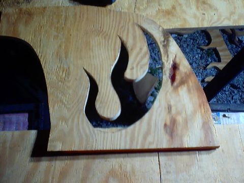 1999 Ford Taurus - A wooden panel with a flame design cut out, possibly for a custom trunk project.