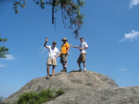 1978 Ford Bronco - Three people pose for a photo on top of a large rock formation on a sunny day.