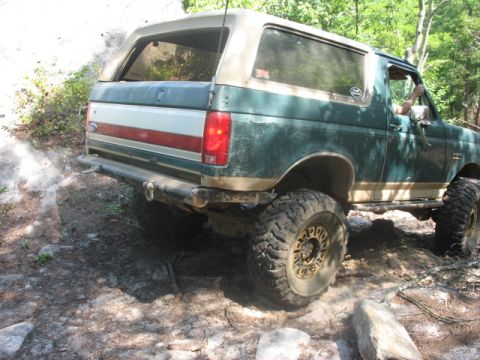 1978 Ford Bronco - This Ford Bronco is navigating a challenging off-road course with large tires and a lifted suspension.