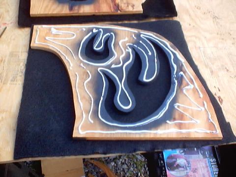 1999 Ford Taurus - A wooden shape is being worked on with sealant, possibly for a custom project.