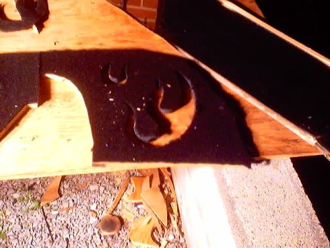 1999 Ford Taurus - A custom-cut felt insert is visible inside a vehicle's trunk, with wooden panels and debris on the ground.