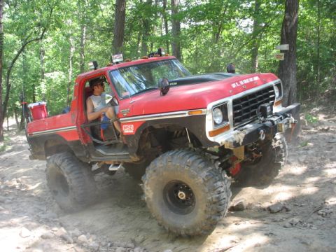 1978 Ford Bronco - This modified 1978 Ford Bronco navigates a wooded trail with its large tires kicking up dust.