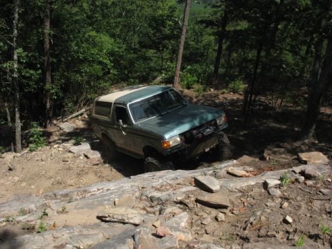 1978 Ford Bronco - This Ford Bronco is navigating a rocky, off-road path in a wooded area.