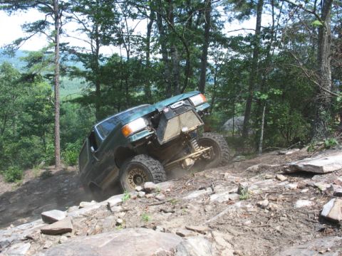 1978 Ford Bronco - This modified truck is navigating a challenging rocky trail, its off-road capabilities.