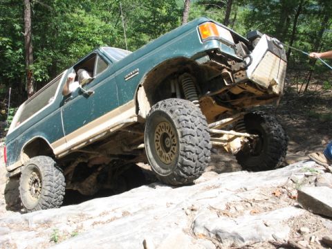 1978 Ford Bronco - This heavily modified SUV navigates a rocky trail, its off-road capabilities.