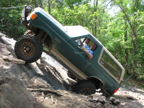1978 Ford Bronco - Off-road enthusiasts tackle a challenging rocky trail in a modified Ford Bronco.