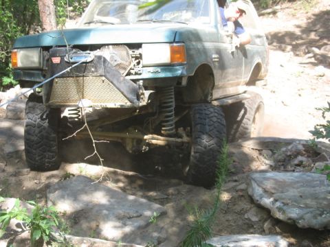 1978 Ford Bronco - Off-road truck with winch and large tires navigating a rocky trail.