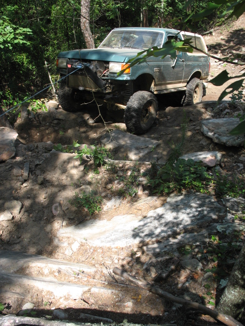 1978 Ford Bronco - This modified Ford Bronco is navigating a difficult rocky terrain on an off-road trail.