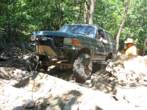 1978 Ford Bronco - Modified SUV tackling a challenging rocky off-road course.