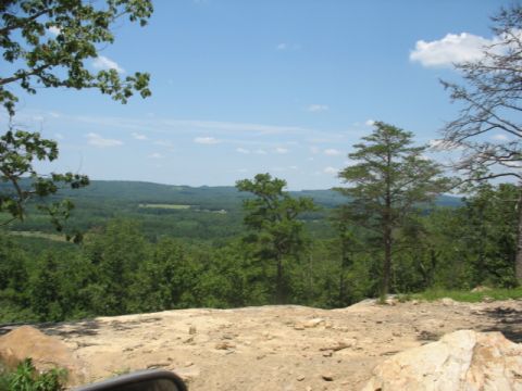 1978 Ford Bronco - Overlooking a vast expanse of forested hills under a bright, partly cloudy sky.
