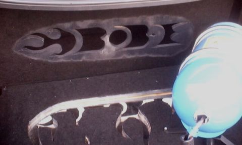 1999 Ford Taurus - Close-up of trunk lining with decorative cutouts and a blue component, spherical object. component.