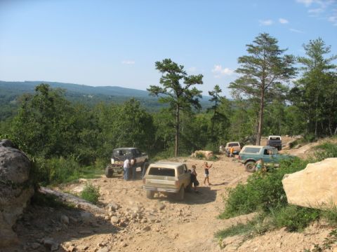 1978 Ford Bronco - Off-roading scene with multiple vehicles on a dirt trail, a 1978 Ford Bronco.