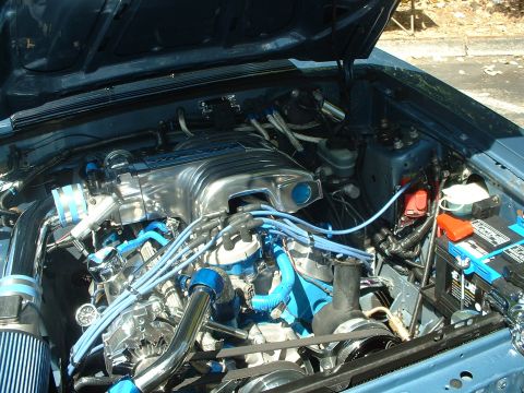 1999 Ford Crown Victoria - Engine bay details with chrome intake and blue accents.