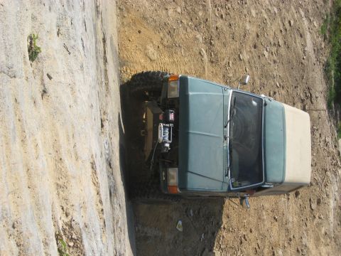 1978 Ford Bronco - This teal SUV with a tan soft top is equipped for off-roading, large tires and a front winch.