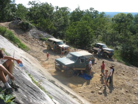1978 Ford Bronco - A group of people and their off-road vehicles are gathered on a rocky, wooded trail.