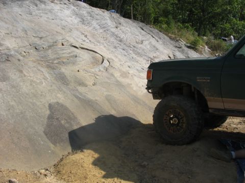 1978 Ford Bronco - Ford Bronco navigating a challenging off-road course on a sunny day.