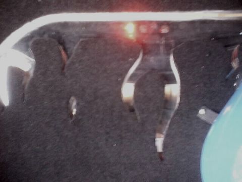 1999 Ford Taurus - The interior of a vehicle's trunk is visible, a light fixture and dark carpeting.