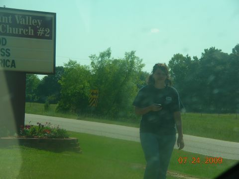 1991 Ford F-150 - A woman stands near a road with a church sign in the background. The date 07.24.2009 is visible.