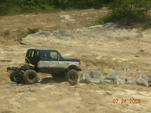 1991 Ford F-150 - Modified 1991 Ford F-150 crew cab navigating a rocky off-road course.