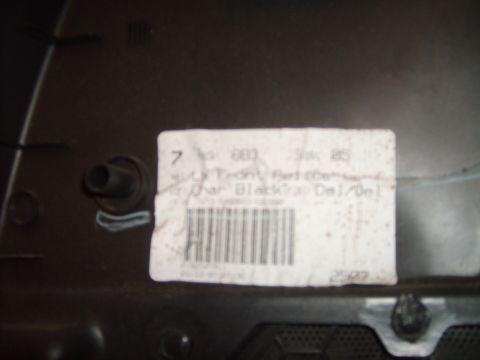 1993 Ford Crown Victoria - A close-up view of a vehicle door panel part, identified by a label indicating 'Char Black'.