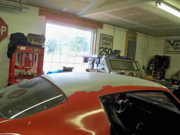 1974 Pontiac Firebird interior and roof undergoing restoration in a garage