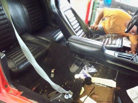 1974 Pontiac Firebird - Interior view of a car, likely from the early 1970s, with a person working on the dashboard.