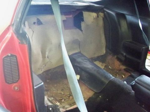 1974 Pontiac Firebird - Interior of a 1974 Pontiac Firebird during restoration, revealing worn upholstery and structural damage.