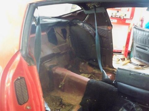 1974 Pontiac Firebird - The interior of a 1974 Pontiac Firebird is shown in a state of restoration, with the rear seating area stripped down.