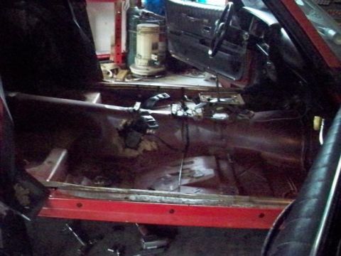 1974 Pontiac Firebird - The interior of a 1974 Pontiac Firebird is shown during a restoration project, with the floor stripped bare.