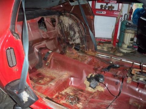 1974 Pontiac Firebird - Interior of a 1974 Pontiac Firebird undergoing restoration, with visible rust and damage.