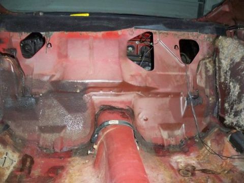 1974 Pontiac Firebird - The interior floor pan of a 1974 Pontiac Firebird shows signs of rust and wear, indicating a need for restoration.