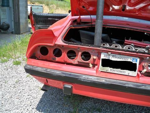 1974 Pontiac Firebird - Rear view of a 1974 Pontiac Firebird undergoing restoration, with the trunk open and license plate visible.