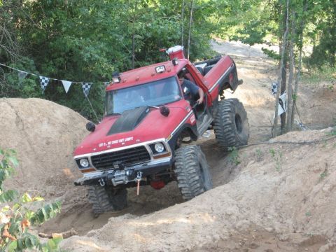 1978 Ford Bronco - Modified 1978 Ford F-series truck tackling an off-road course with extreme suspension.