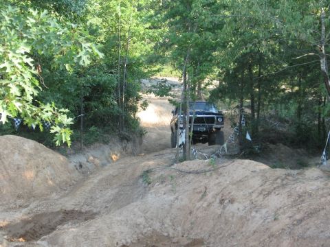 1978 Ford Bronco - This vehicle is navigating a challenging off-road course marked with flags.