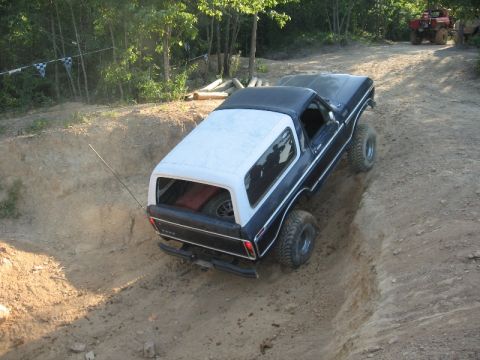 1978 Ford Bronco - A 1978 Ford Bronco tackles a challenging off-road course, with another vehicle visible in the background.