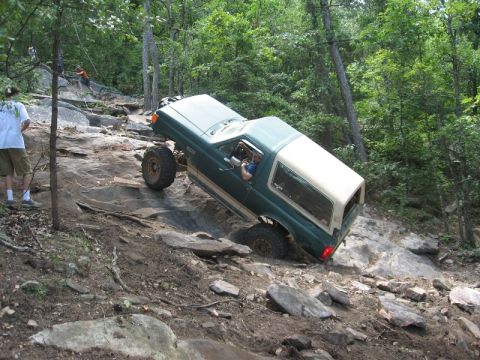 1978 Ford Bronco - 1978 Ford Bronco navigating a challenging rocky off-road course.