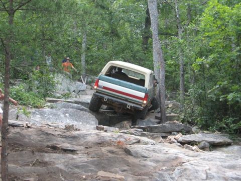 1978 Ford Bronco - A 1978 Ford Bronco tackles a challenging off-road course with steep inclines and large rocks.