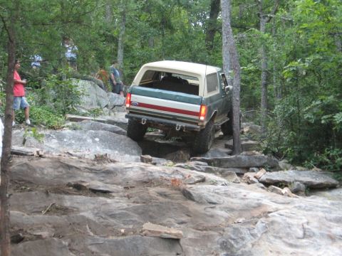 1978 Ford Bronco - Ford Bronco tackling a challenging off-road course on a summer day.