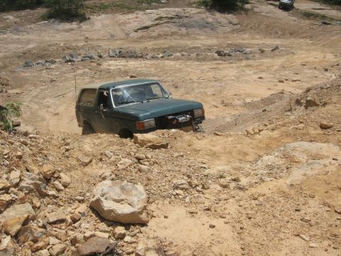1978 Ford Bronco - This green SUV is stuck in a dirt terrain, with another vehicle visible in the background. The watermark indicates the source is Supermotor…