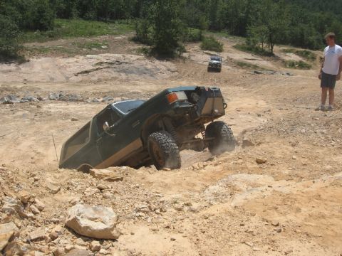 1978 Ford Bronco - This SUV is navigating a challenging off-road course and appears to be stuck in the dirt.